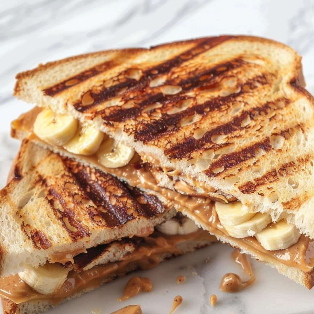 Grilled loaf of bread with banana and peanut butter filling.